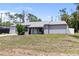 Charming single-story home featuring gray paint and a well-manicured front yard at 16834 Toledo Blade Blvd, Port Charlotte, FL 33954