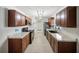 Contemporary eat-in kitchen with tile flooring, granite counters, and wooden cabinets at 16834 Toledo Blade Blvd, Port Charlotte, FL 33954