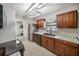 Galley kitchen features stainless steel appliances, granite countertops, and dark wood cabinetry at 16834 Toledo Blade Blvd, Port Charlotte, FL 33954