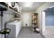 Inside laundry room with washer, dryer, storage shelves, and backyard access at 16834 Toledo Blade Blvd, Port Charlotte, FL 33954