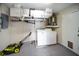 Functional laundry area with washer, dryer, utility shelving, and access to outdoor spaces at 16834 Toledo Blade Blvd, Port Charlotte, FL 33954