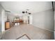 Open-concept living and dining area with tile flooring and neutral gray paint throughout at 16834 Toledo Blade Blvd, Port Charlotte, FL 33954