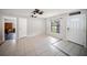 Cozy living room area featuring tiled flooring, a ceiling fan, and front door access at 16834 Toledo Blade Blvd, Port Charlotte, FL 33954
