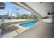 Inviting screened-in pool area with a spacious patio, perfect for outdoor relaxation and entertaining at 16834 Toledo Blade Blvd, Port Charlotte, FL 33954