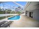 Backyard view featuring the pool, patio area, and seating perfect for outdoor entertaining at 16834 Toledo Blade Blvd, Port Charlotte, FL 33954