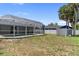 View of the backyard with screen-enclosed pool and lounging area at 16834 Toledo Blade Blvd, Port Charlotte, FL 33954