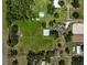 Aerial view of property featuring home, barn, pastures, trees and surroundings at 16918 Waterline Rd, Bradenton, FL 34212