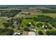 Expansive aerial view of the property showcasing the house, pastures, trees, and surrounding landscape at 16918 Waterline Rd, Bradenton, FL 34212