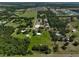 Wide aerial shot showcasing the house and property in a serene, expansive setting with beautiful green landscape at 16918 Waterline Rd, Bradenton, FL 34212
