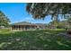 Expansive backyard featuring a screened lanai, lush greenery, and comfortable patio seating at 16918 Waterline Rd, Bradenton, FL 34212