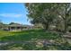 Expansive backyard featuring a screened lanai, lush greenery, and comfortable patio seating at 16918 Waterline Rd, Bradenton, FL 34212