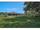 Expansive backyard featuring a screened lanai, lush greenery, and comfortable patio seating at 16918 Waterline Rd, Bradenton, FL 34212