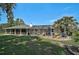 Expansive backyard featuring a screened lanai, lush greenery, and comfortable patio seating at 16918 Waterline Rd, Bradenton, FL 34212