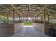 Spacious barn interior with multiple stalls, high ceilings, and ample natural light at 16918 Waterline Rd, Bradenton, FL 34212