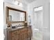 Charming bathroom with a wooden vanity, granite counter, and walk-in shower at 16918 Waterline Rd, Bradenton, FL 34212