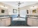Bright bathroom features separate sinks, large tub, modern fixtures, and stylish lighting at 16918 Waterline Rd, Bradenton, FL 34212