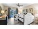 Bright bedroom featuring two beds, curtains, and a sliding glass door to the outdoors at 16918 Waterline Rd, Bradenton, FL 34212