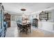 Elegant dining room featuring decorative chandelier, china cabinets, and formal table setting at 16918 Waterline Rd, Bradenton, FL 34212