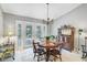 Charming dining room showcases stylish light fixture, backyard views, and dark wood furniture at 16918 Waterline Rd, Bradenton, FL 34212