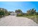 Wide shot of home with an attached garage, circular drive, and landscaping at 16918 Waterline Rd, Bradenton, FL 34212