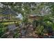 Charming garden space with potted plants, benches, and shaded seating areas at 16918 Waterline Rd, Bradenton, FL 34212