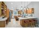 Spacious kitchen with custom wood cabinets, tile floors, and a center island with seating at 16918 Waterline Rd, Bradenton, FL 34212