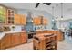 Updated kitchen with wood cabinets, stainless appliances, and kitchen island at 16918 Waterline Rd, Bradenton, FL 34212