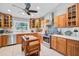 Modern kitchen featuring wood cabinets, stainless steel appliances, and decorative backsplash at 16918 Waterline Rd, Bradenton, FL 34212