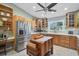 Well-lit kitchen equipped with stainless steel refrigerator, custom island, and plenty of storage space at 16918 Waterline Rd, Bradenton, FL 34212