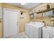 Functional laundry room with washer, dryer, storage shelves, and utility sink at 16918 Waterline Rd, Bradenton, FL 34212