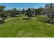 Spacious lot with lush green grass, partially fenced and dotted with mature trees, ideal for recreation at 16918 Waterline Rd, Bradenton, FL 34212
