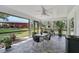 Screened in patio features tile flooring and furniture to enjoy the view of the backyard at 16918 Waterline Rd, Bradenton, FL 34212