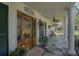 Inviting covered front porch with stone tile flooring and decorative columns at 16918 Waterline Rd, Bradenton, FL 34212