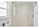 Bright shower featuring glass door, white tile, and window at 16918 Waterline Rd, Bradenton, FL 34212