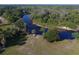 Breathtaking aerial view of a river winding through a lush green landscape, with a golf cart by the river at 16943 Rosedown Gln, Parrish, FL 34219