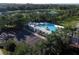 Aerial view of community pool, clubhouse, parking and surrounding landscaping at 16943 Rosedown Gln, Parrish, FL 34219