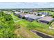 Community aerial view showcasing homes with screened lanais, lush greenery, and water features at 16943 Rosedown Gln, Parrish, FL 34219