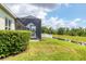 Green backyard overlooking pond with screen enclosed lanai at 16943 Rosedown Gln, Parrish, FL 34219