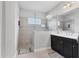 Bathroom featuring an enclosed shower, single vanity with black cabinets, and tile flooring at 16943 Rosedown Gln, Parrish, FL 34219