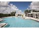 Large community pool with ample seating and lounge area, with pool house featuring grilling area at 16943 Rosedown Gln, Parrish, FL 34219