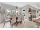Bright dining room featuring a modern chandelier, a large table, and access to the outdoors at 16943 Rosedown Gln, Parrish, FL 34219
