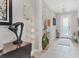 Bright and modern foyer featuring neutral walls, tiled floors, elegant decor, and a stylish chandelier at 16943 Rosedown Gln, Parrish, FL 34219