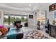 Bright living room with sliding glass doors to the outdoors and stylish seating creating seamless indoor-outdoor living at 16943 Rosedown Gln, Parrish, FL 34219