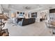 Open-concept living space with modern decor, tile flooring, and seamless flow to kitchen and dining areas at 16943 Rosedown Gln, Parrish, FL 34219