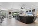 Spacious open concept living room featuring a modern ceiling fan and seamless transition to the kitchen and dining spaces at 16943 Rosedown Gln, Parrish, FL 34219