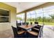Covered patio with a grill and dark wicker patio furniture overlooking the backyard at 16943 Rosedown Gln, Parrish, FL 34219