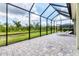 Screened-in patio featuring brick-paved flooring and two lounge chairs at 16943 Rosedown Gln, Parrish, FL 34219