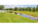 Serene pond view with lush greenery, enhancing the tranquil setting of the property at 16943 Rosedown Gln, Parrish, FL 34219