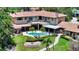 Stunning aerial view showcasing a home with a red tile roof, backyard pool, and meticulously landscaped gardens at 203 Robin Dr, Sarasota, FL 34236