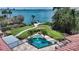 Overhead view of a backyard oasis with pool, spa, lush landscaping and private dock at 203 Robin Dr, Sarasota, FL 34236